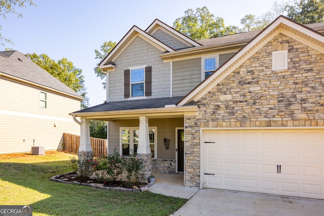 craftsman-style home featuring a porch, a front yard, and central AC