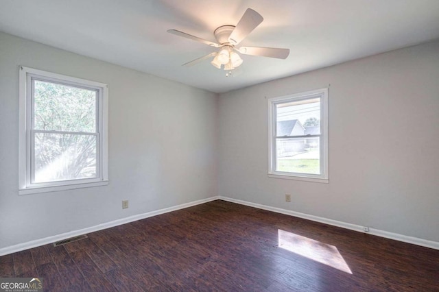 empty room featuring dark hardwood / wood-style floors and ceiling fan