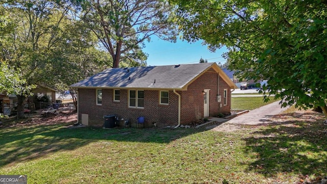 view of side of home with a lawn