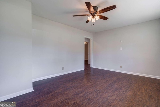 spare room featuring dark wood-type flooring and ceiling fan