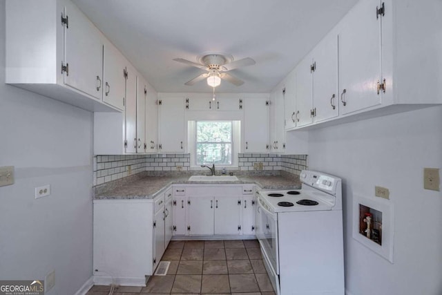 kitchen with sink, backsplash, electric range, ceiling fan, and white cabinets