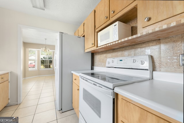 kitchen with light tile patterned floors, backsplash, a chandelier, pendant lighting, and white appliances