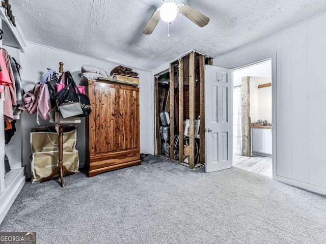 interior space with ceiling fan and light colored carpet