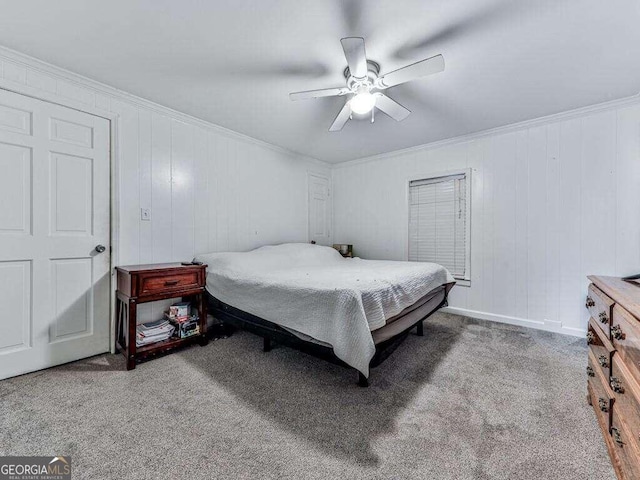 carpeted bedroom with wooden walls, crown molding, and ceiling fan