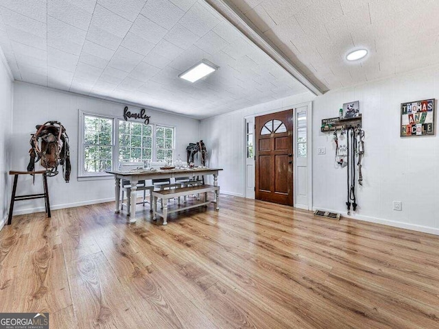 dining room with a textured ceiling and light wood-type flooring