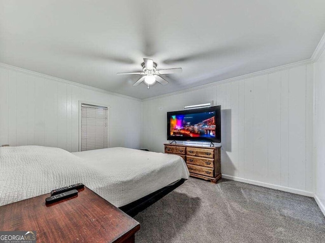 carpeted bedroom with wood walls, crown molding, and ceiling fan