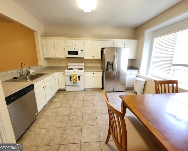 kitchen featuring white cabinetry, light tile patterned floors, appliances with stainless steel finishes, and sink