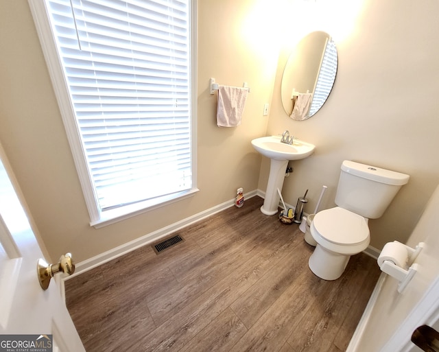 bathroom featuring toilet, sink, and hardwood / wood-style floors