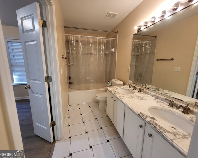 full bathroom with toilet, shower / tub combo with curtain, vanity, and tile patterned floors