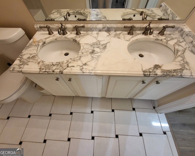 bathroom featuring vanity, toilet, and tile patterned floors