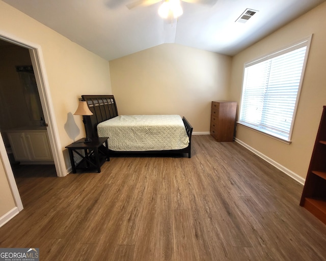 bedroom featuring vaulted ceiling, dark hardwood / wood-style floors, and ceiling fan