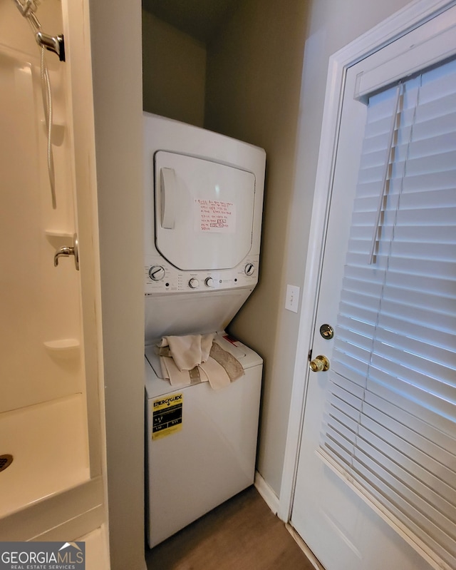 laundry room featuring stacked washer / drying machine