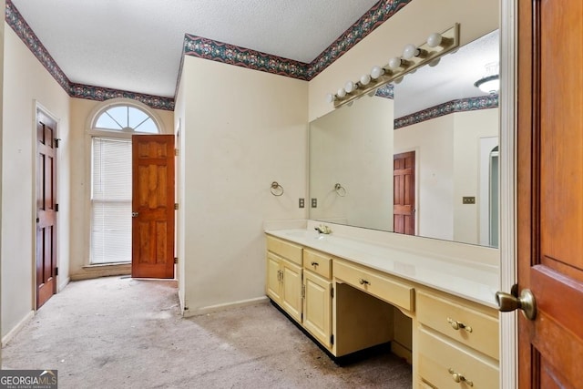 bathroom with vanity and a textured ceiling