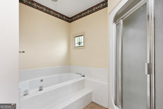 bathroom featuring shower with separate bathtub