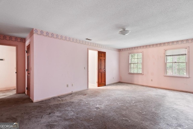 empty room with a textured ceiling