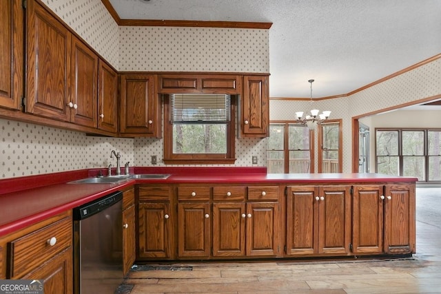 kitchen featuring light wood-type flooring, sink, pendant lighting, an inviting chandelier, and dishwasher