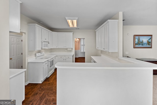 kitchen featuring white cabinets, kitchen peninsula, white appliances, and dark hardwood / wood-style flooring