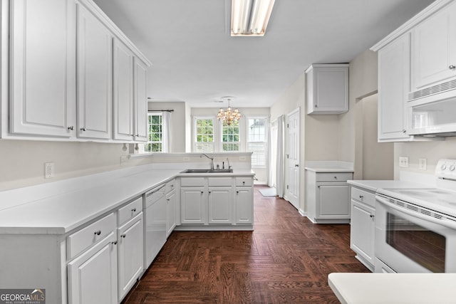 kitchen featuring sink, white cabinets, decorative light fixtures, and white appliances