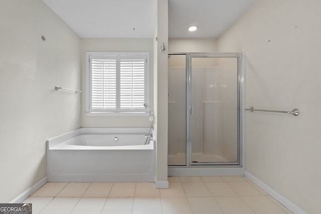 bathroom featuring tile patterned floors and separate shower and tub