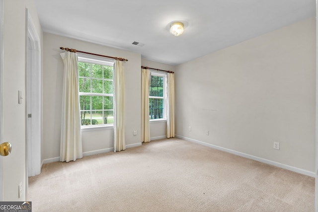 empty room featuring light colored carpet