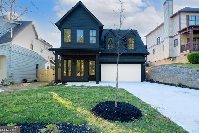 view of front of home featuring a garage and a front lawn