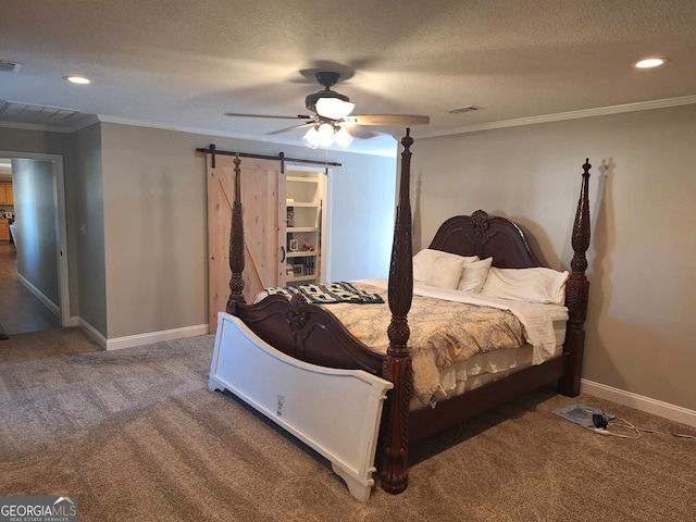 carpeted bedroom featuring crown molding, ceiling fan, a barn door, and a textured ceiling