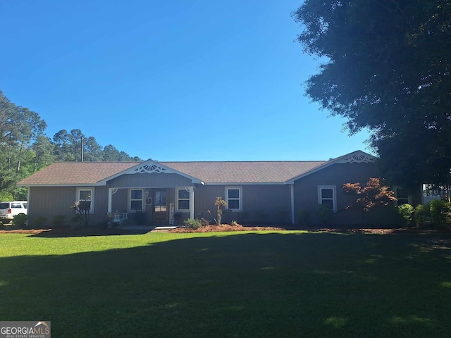 rear view of property featuring a yard