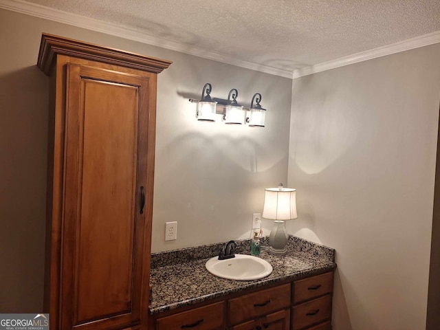 bathroom with vanity, ornamental molding, and a textured ceiling