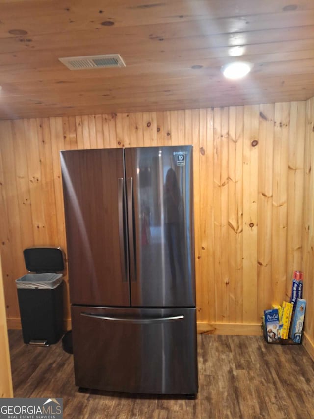 kitchen featuring stainless steel fridge, wooden ceiling, dark hardwood / wood-style floors, and wooden walls