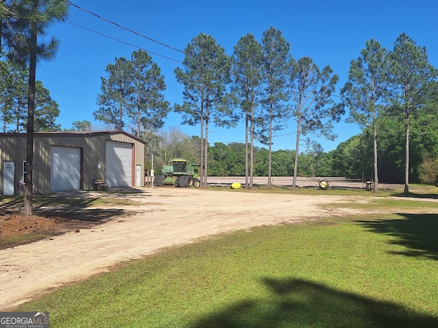 view of yard featuring an outbuilding and a garage