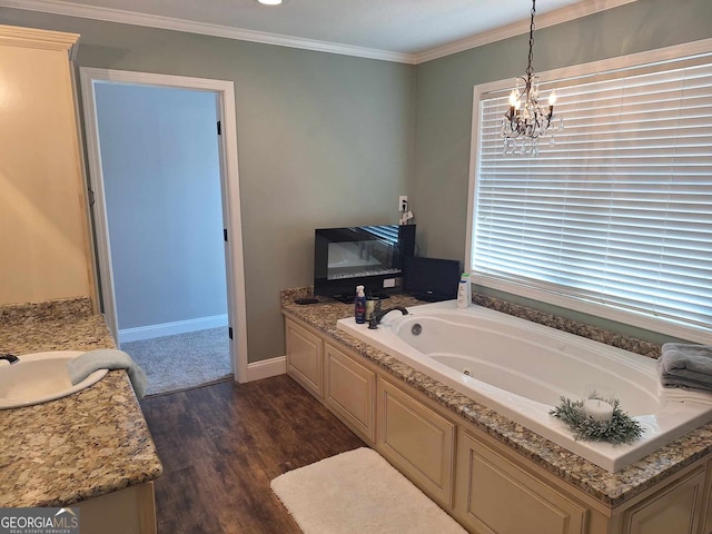 bathroom featuring hardwood / wood-style floors, vanity, a notable chandelier, crown molding, and a bath