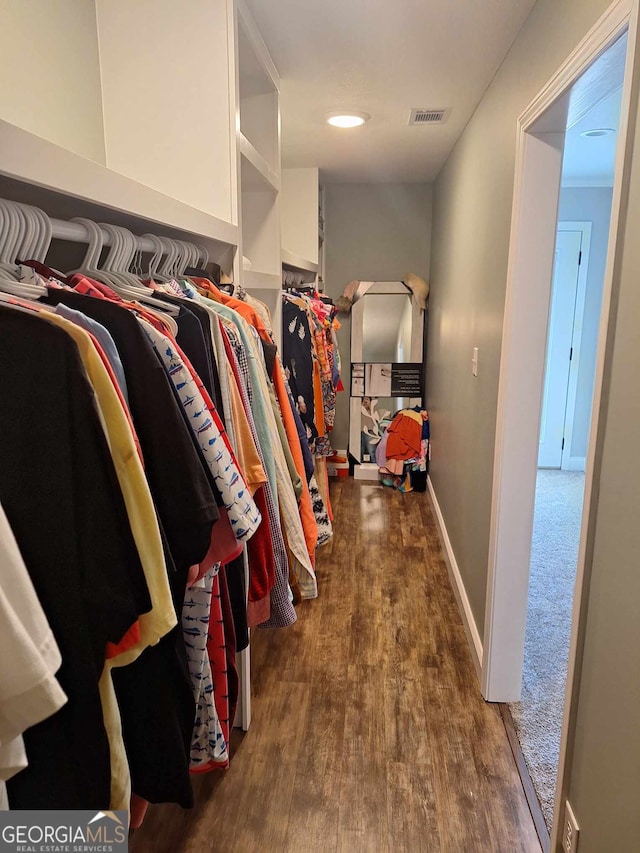 spacious closet featuring dark hardwood / wood-style flooring