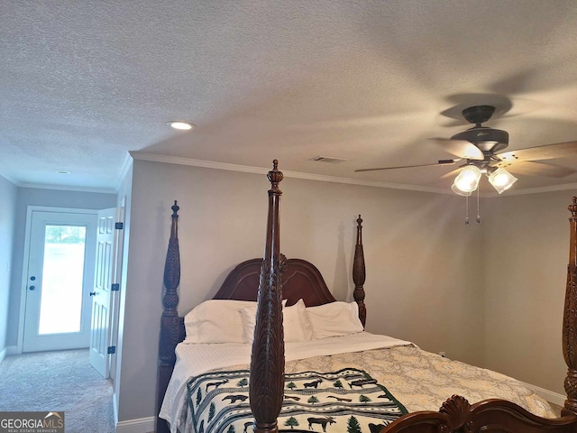 bedroom featuring ceiling fan, carpet floors, ornamental molding, and a textured ceiling