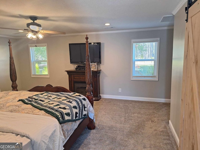 carpeted bedroom featuring crown molding, ceiling fan, and a barn door