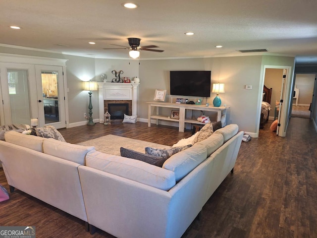 living room with crown molding, ceiling fan, and dark hardwood / wood-style flooring