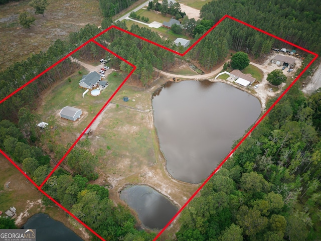 birds eye view of property with a water view