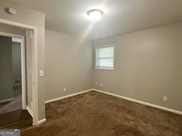 empty room with dark carpet