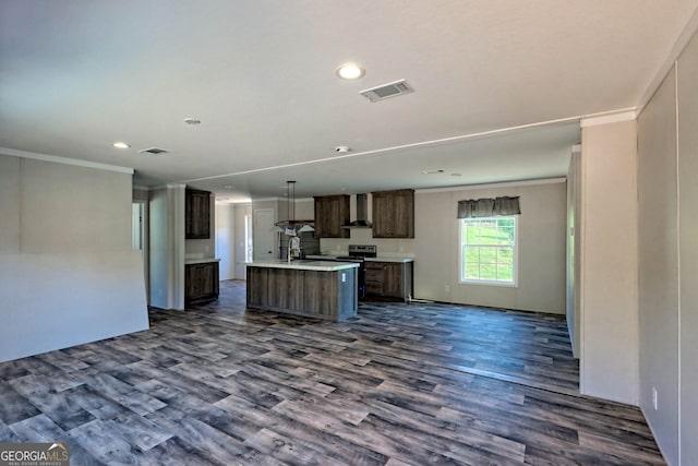 kitchen featuring a center island with sink, ornamental molding, dark hardwood / wood-style floors, and wall chimney exhaust hood