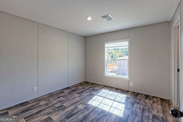 unfurnished room with dark wood-type flooring