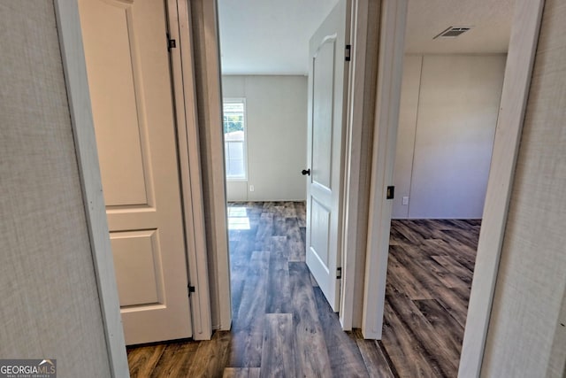 hallway with dark wood-type flooring