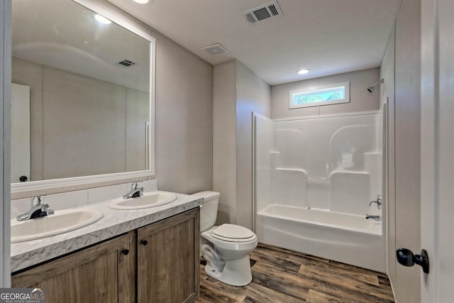 full bathroom featuring vanity, toilet, shower / bath combination, and hardwood / wood-style floors