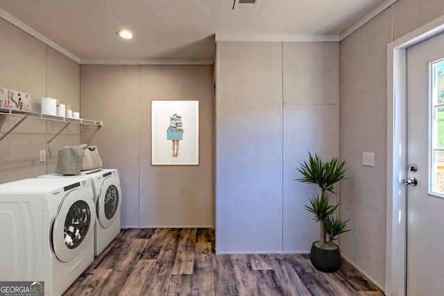 clothes washing area with crown molding, dark hardwood / wood-style floors, and independent washer and dryer