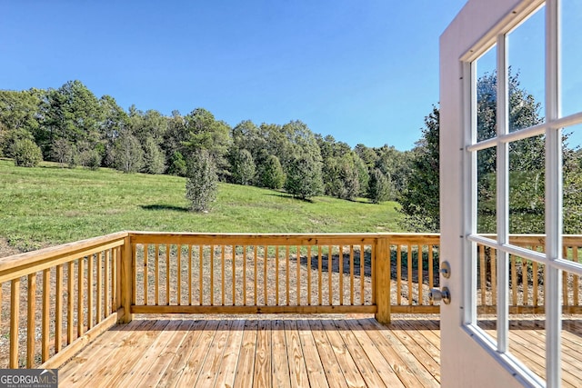 wooden terrace featuring a yard