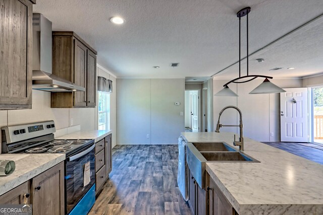 kitchen featuring appliances with stainless steel finishes, a healthy amount of sunlight, and a kitchen island with sink