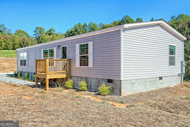 back of property featuring a yard and a deck