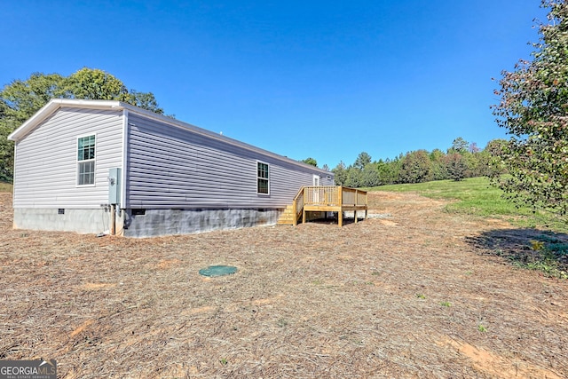 view of side of property featuring a wooden deck