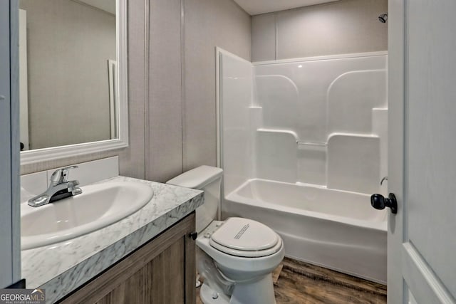 full bathroom with wood-type flooring, bathtub / shower combination, vanity, and toilet