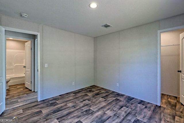 unfurnished bedroom with dark wood-type flooring