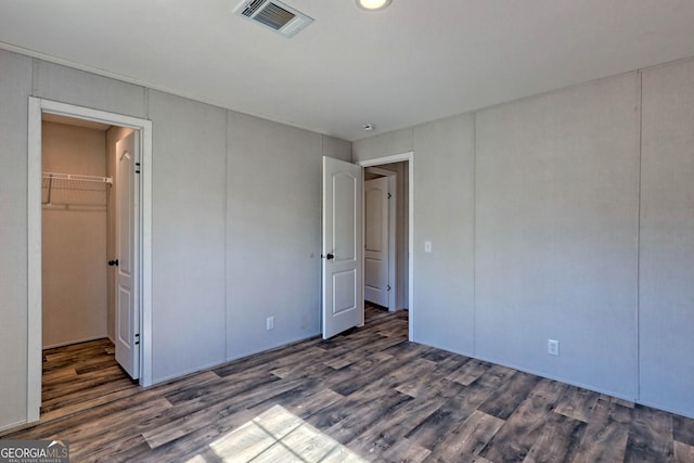 unfurnished bedroom featuring dark hardwood / wood-style floors