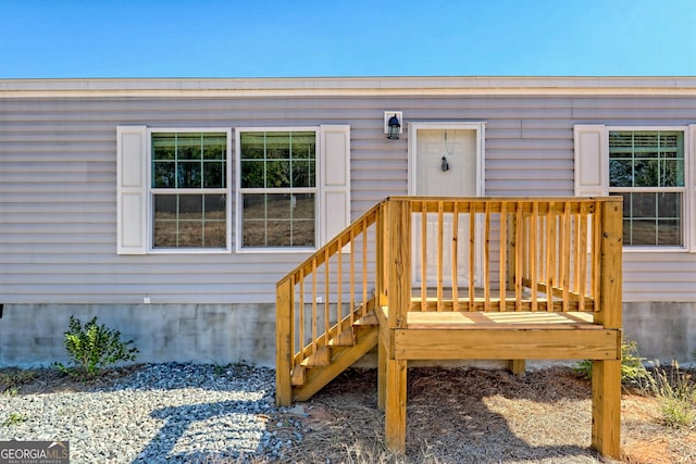 view of exterior entry with a wooden deck